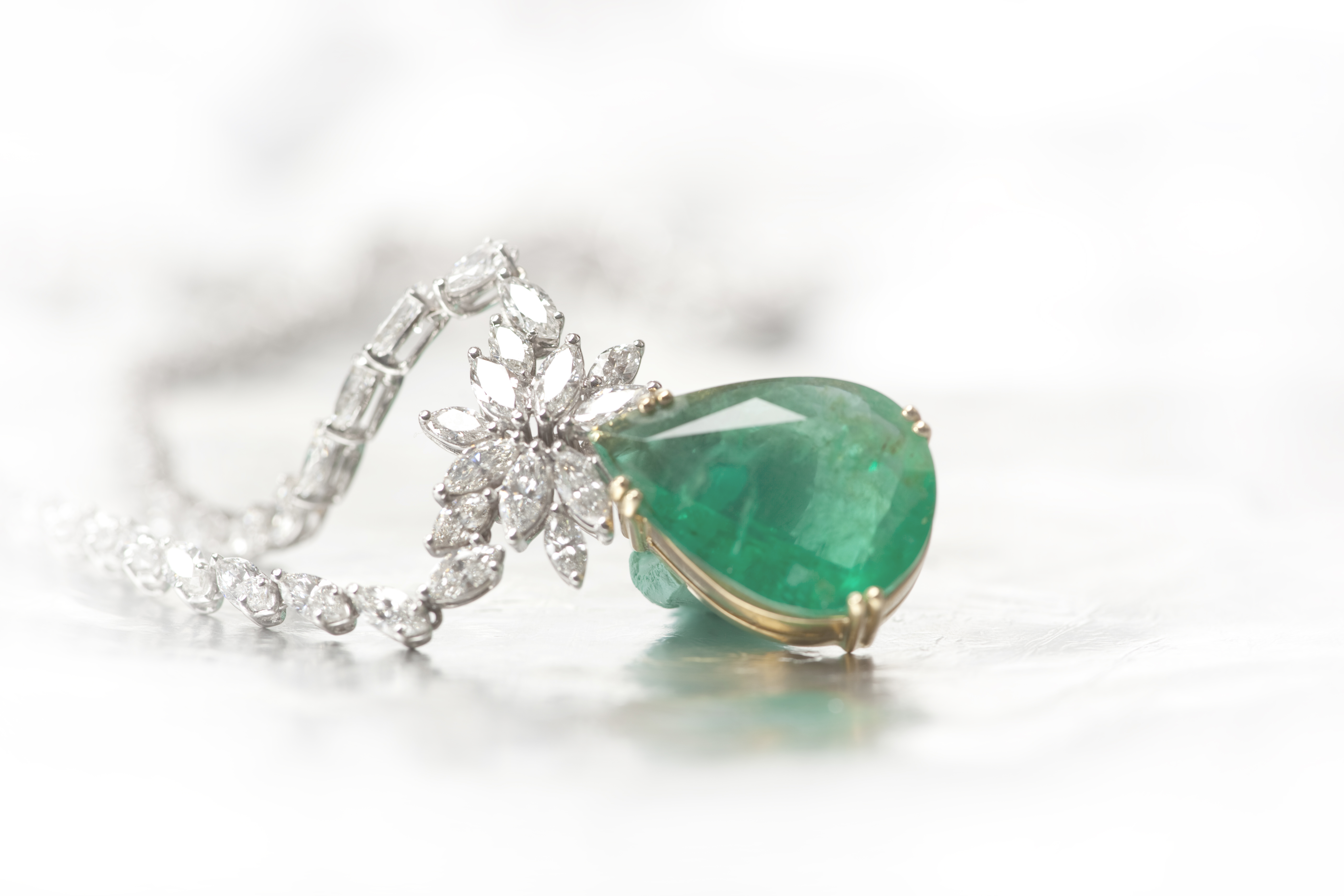 Image of a high-value necklace with a green stone.