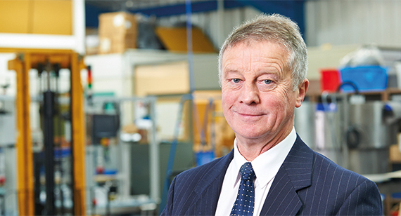 Suited grey haired businessman in warehouse