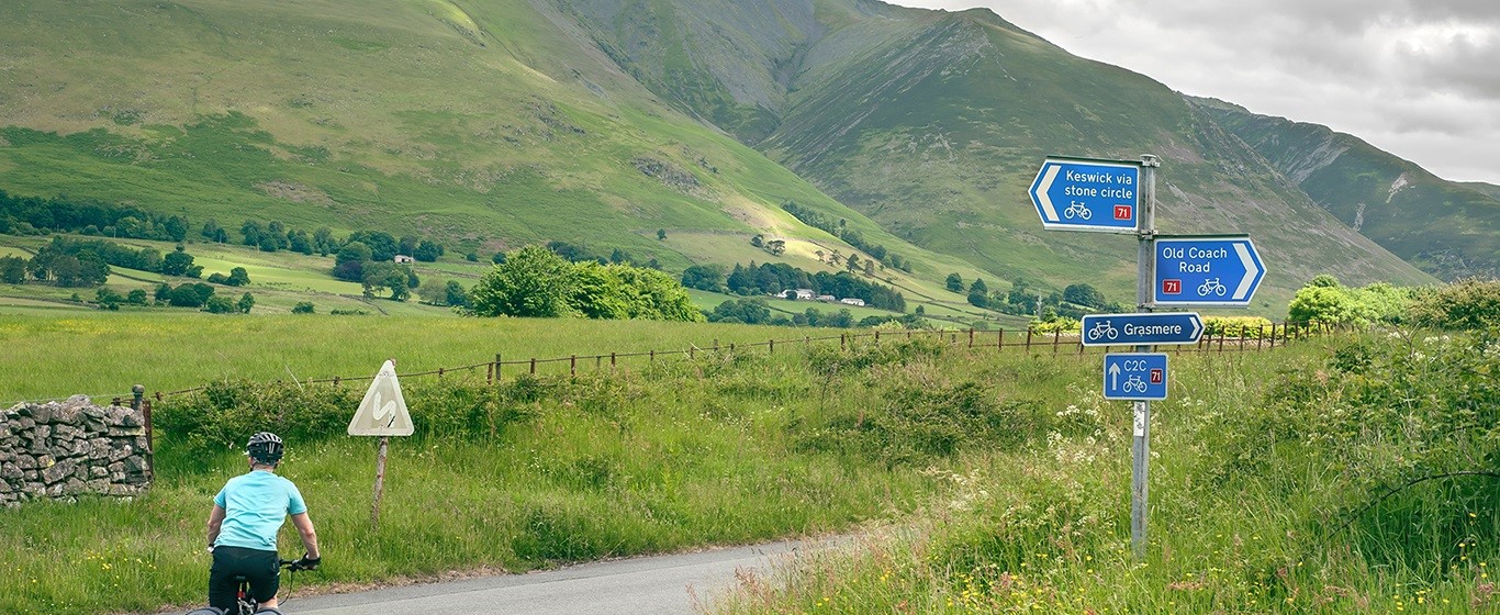 cyclist at rural road junction 1366x560.jpg