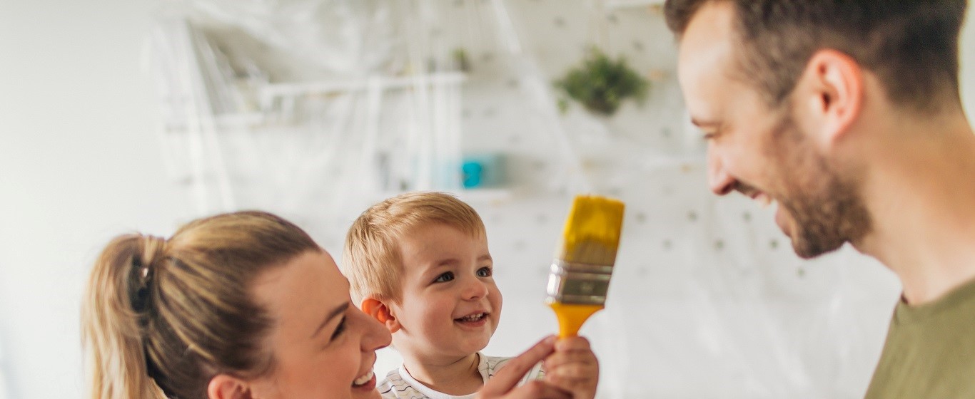 young family repainting a room